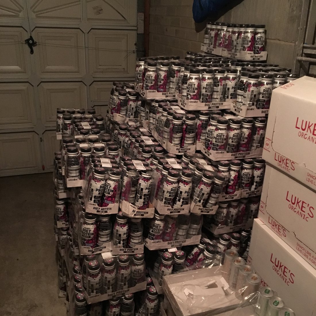 Pallets of stock filling a domestic garage, February 2018